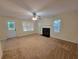 Cozy living room with a fireplace, ceiling fan, and door to the backyard with lots of natural light at 180 Preston Oaks Dr, Johns Creek, GA 30022