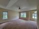 Spacious main bedroom with tray ceilings, ceiling fan, carpet and double hung windows at 180 Preston Oaks Dr, Johns Creek, GA 30022