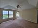 Spacious main bedroom with tray ceilings, ceiling fan, carpet and double hung windows at 180 Preston Oaks Dr, Johns Creek, GA 30022