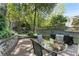 Beautiful backyard with a patio, dining set, lush greenery, pond and a stone waterfall feature at 22 The Prado Ne, Atlanta, GA 30309