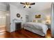 Cozy bedroom featuring hardwood floors, fireplace, decorative mantel, and ample natural light at 22 The Prado Ne, Atlanta, GA 30309