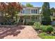 Charming home featuring a brick driveway, landscaped yard, and inviting covered front porch at 22 The Prado Ne, Atlanta, GA 30309