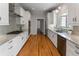 Galley kitchen features stainless steel appliances, white cabinets, and granite countertops at 22 The Prado Ne, Atlanta, GA 30309