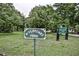 A well maintained neighborhood green space features lush lawns, mature trees and pleasant signage at 22 The Prado Ne, Atlanta, GA 30309