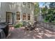 Charming brick patio featuring an outdoor dining set, mature trees and an exterior view of the house at 22 The Prado Ne, Atlanta, GA 30309