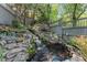 Picturesque backyard waterfall and pond creating a serene outdoor oasis with lush plants and stone accents at 22 The Prado Ne, Atlanta, GA 30309