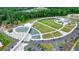 Aerial view of a park with a water feature, pedestrian bridge, green space, and parking at 400 Pringle Dr, Suwanee, GA 30024