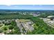 Aerial view of a residential neighborhood with a community pool surrounded by lush greenery at 400 Pringle Dr, Suwanee, GA 30024