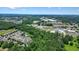 Aerial view of a community with a town center, green spaces, and winding walkways at 400 Pringle Dr, Suwanee, GA 30024