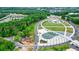 Overhead view of a park featuring a splashpad, playgrounds, water features, pedestrian bridge, and green spaces at 400 Pringle Dr, Suwanee, GA 30024