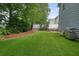 Beautiful backyard with green turf, white fence, and privacy landscaping at 400 Pringle Dr, Suwanee, GA 30024