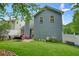 Backyard view with green turf, outdoor seating, barbecue, and privacy fence at 400 Pringle Dr, Suwanee, GA 30024