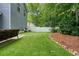 Backyard showing green turf and outdoor seating area with privacy fence at 400 Pringle Dr, Suwanee, GA 30024