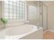 The bathroom features a soaking tub and glass enclosed shower with tile surround at 400 Pringle Dr, Suwanee, GA 30024