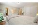 This bedroom has a bed with a patterned blanket, dresser, and decor at 400 Pringle Dr, Suwanee, GA 30024