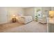 Cozy bedroom with a comfortable bed, side table, and decorative armchair at 400 Pringle Dr, Suwanee, GA 30024