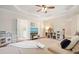 Spacious bonus room features a tray ceiling, playroom area and access to bathroom at 400 Pringle Dr, Suwanee, GA 30024