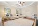 Bright bonus room offering space to relax featuring tray ceiling, area rug, and large sectional at 400 Pringle Dr, Suwanee, GA 30024