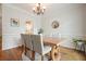 Dining room with chandelier, white wainscoting, and hardwood flooring at 400 Pringle Dr, Suwanee, GA 30024