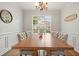 Dining room with a large table and chairs underneath a decorative chandelier at 400 Pringle Dr, Suwanee, GA 30024