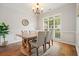 Formal dining room with wainscoting, chandelier, and large window at 400 Pringle Dr, Suwanee, GA 30024