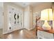 Inviting entryway featuring a white door with sidelights and hardwood flooring at 400 Pringle Dr, Suwanee, GA 30024