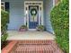 Inviting front entrance with a blue door, wreath, and neatly trimmed bushes at 400 Pringle Dr, Suwanee, GA 30024