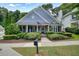Charming home with blue siding, manicured landscaping, and a welcoming front porch at 400 Pringle Dr, Suwanee, GA 30024