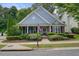 Charming home with blue siding, manicured landscaping, and a welcoming front porch at 400 Pringle Dr, Suwanee, GA 30024