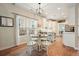 Open kitchen with white cabinets, hardwood floors, and casual dining area at 400 Pringle Dr, Suwanee, GA 30024
