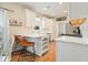 Bright kitchen with white cabinets, stainless steel appliances and hardwood floors at 400 Pringle Dr, Suwanee, GA 30024