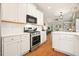 Bright white kitchen with stainless appliances and hardwood floors at 400 Pringle Dr, Suwanee, GA 30024