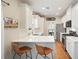 Modern kitchen with stainless steel appliances, white cabinets, and barstool seating at 400 Pringle Dr, Suwanee, GA 30024