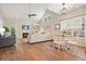 Open living room featuring vaulted ceilings, a fireplace, hardwood floors, and a cozy dining area at 400 Pringle Dr, Suwanee, GA 30024