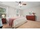 The main bedroom has natural light and wood accents and a carpeted floor at 400 Pringle Dr, Suwanee, GA 30024