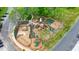 Aerial shot of a fenced playground with climbing structures, slides, and safety surfacing at 400 Pringle Dr, Suwanee, GA 30024