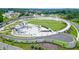 High-angle shot displaying a vibrant town center with a large lawn and pedestrian bridge at 400 Pringle Dr, Suwanee, GA 30024