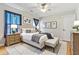 Cozy bedroom with a king bed, blue curtains, matching nightstands, and decorative wall art at 4497 Black Water Cv, Ellenwood, GA 30294