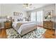Bedroom featuring natural light, wood floors, stylish decor and a decorative rug at 4497 Black Water Cv, Ellenwood, GA 30294