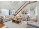 Bright living room showcasing hardwood floors and a soaring ceiling at 4497 Black Water Cv, Ellenwood, GA 30294