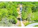 Wide aerial shot showcases home with long driveway bordered with mature trees and lush surroundings at 90 Ayers Rd, Bowdon, GA 30108