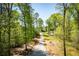 Picturesque view of private driveway leading to property entrance surrounded by a beautiful wooded area at 90 Ayers Rd, Bowdon, GA 30108