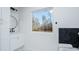 Well-lit bathroom features a tub, vanity, and a large window at 90 Ayers Rd, Bowdon, GA 30108