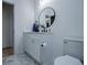 Bathroom showcasing white vanity, round mirror, and toilet with a clean, minimalist design at 90 Ayers Rd, Bowdon, GA 30108