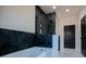 Walk-in shower with black hexagon tile and glass door at 90 Ayers Rd, Bowdon, GA 30108