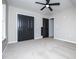 Spacious bedroom with carpet, ceiling fan, closet with dark doors, and plenty of natural light at 90 Ayers Rd, Bowdon, GA 30108
