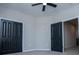 View of bedroom showcasing closet, fan, and open doorway at 90 Ayers Rd, Bowdon, GA 30108