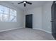 Bedroom features plush carpet, black closet, and ceiling fan at 90 Ayers Rd, Bowdon, GA 30108