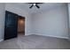 Spacious bedroom showcases the carpet, paint, ceiling fan, and open door at 90 Ayers Rd, Bowdon, GA 30108