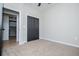Comfortable bedroom featuring modern gray closet doors and neutral carpet, perfect for relaxation at 90 Ayers Rd, Bowdon, GA 30108